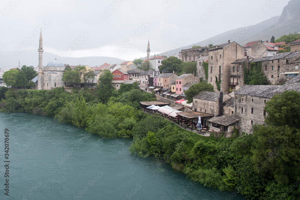 Views of Mostar with colored facades and roofs on the banks of the Neretva River in Bosnia, Europe.