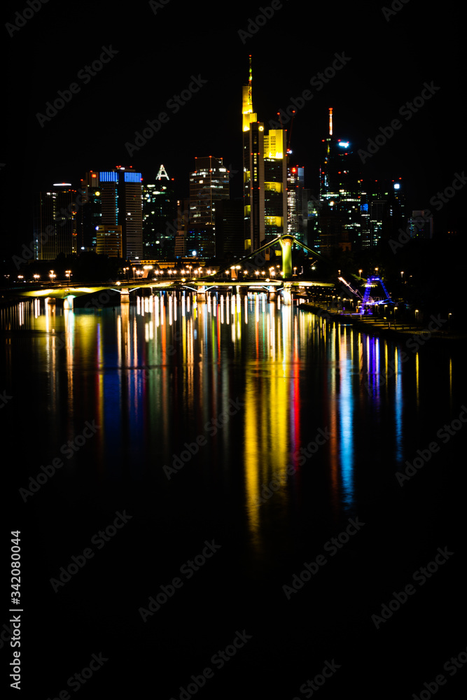 buildings and city reflections in Frankfurt city over the main river and ignatz bubis bridge, Germany