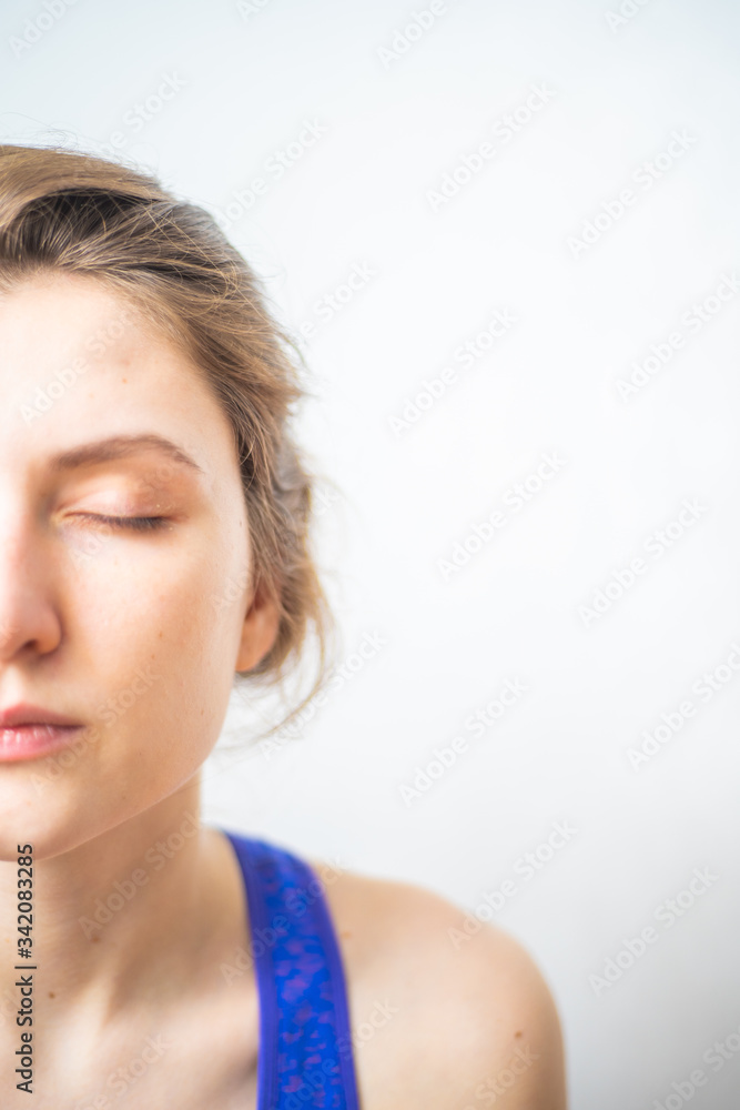 Half female face close-up, copyspace. Breathing exercises, concentration and mental cleansing Half female face close-up, copyspace. Breathing exercises, concentration and mental cleansing