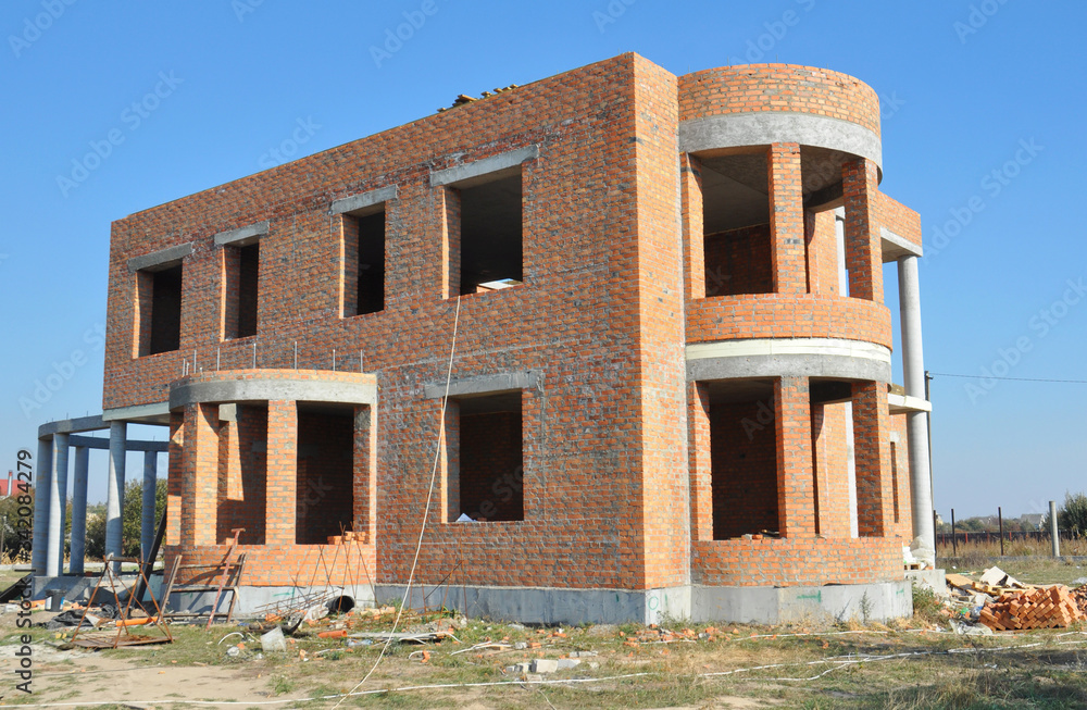 Luxury brick house, semi circular shaped villa building with a winter garden, glass green house under construction.