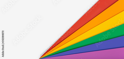 Rainbow flag banner background with copy space. Gay pride flag or LGBTQ pride flag. Photo of a Group of Colorful cardboard on white background