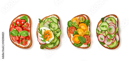 Open sandwiches with vegetables cherry tomato, cucumber, radish. Italian vegan bruschetta with soft cheese. Various sandwich with spinach isolated on white background, top view. Flat lay