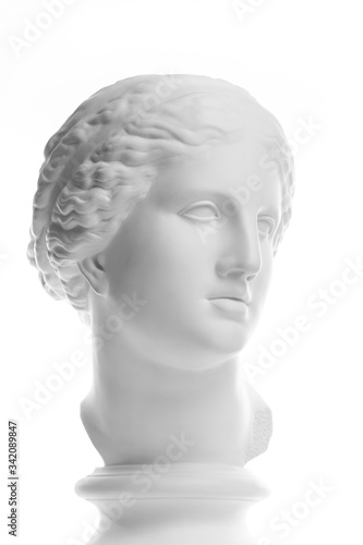 Gypsum copy of ancient statue Venus head isolated on white background. Plaster sculpture woman face.
