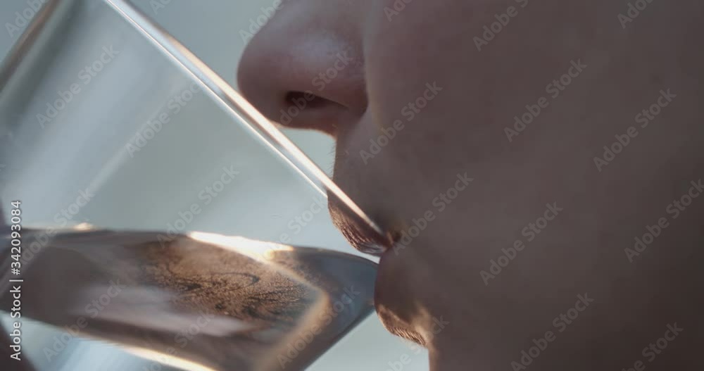 female lips drinking water from a transparent glass. 4k slow motion