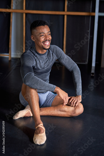 Photo portrait of a black boy with sport clothes and slippers and ballet in a dance academy