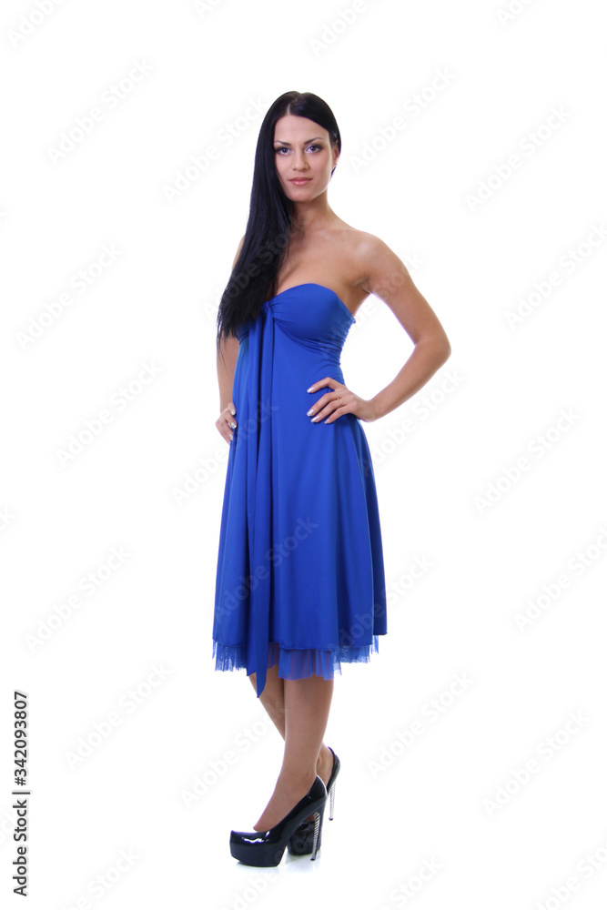 Portrait of a young beautiful brunette woman in blue dress