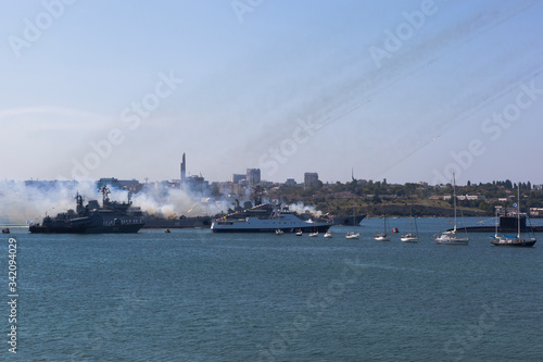 The large landing craft Caesar Kunikov and Azov are firing from Grad-M multiple launch rocket systems at the Navy Day parade in the hero city of Sevastopol, Crimea