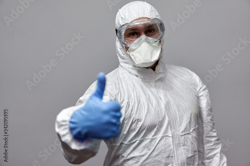 Man in overall suit showing thumbs up photo