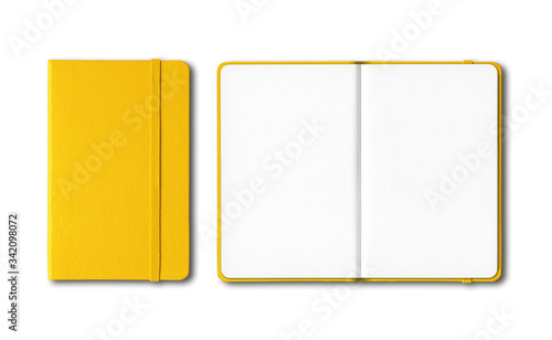 Yellow closed and open notebooks isolated on white photo