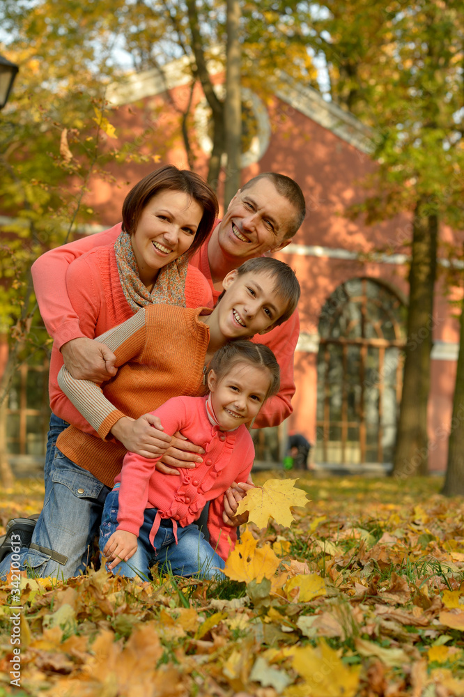 Portrait of happy young family in autumn park Portrait of happy young family in autumn park