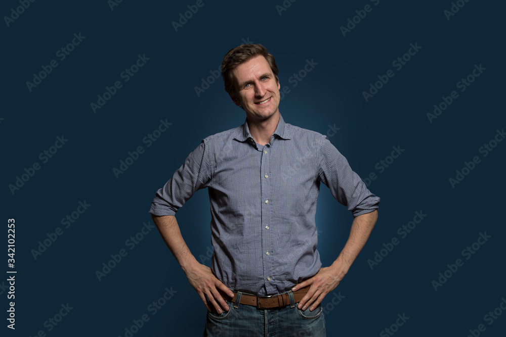Man with Hands on Hips Smiling with Head Slanted Man with Hands on Hips Smiling with Head Slanted