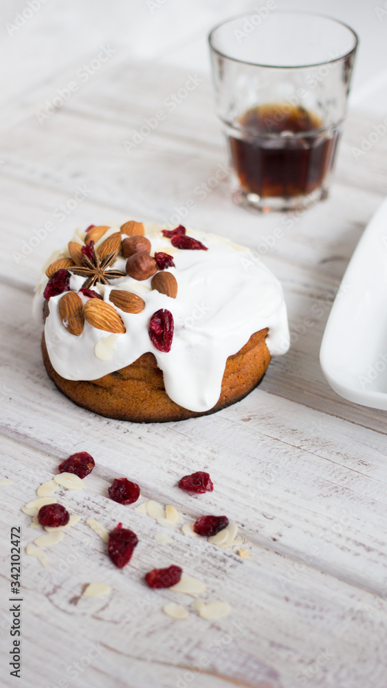 Cake with white cream, almonds and hazelnuts on a dark background. Sweet food. Sweet dessert. Cake with white cream, almonds and hazelnuts on a dark background. Sweet food. Sweet dessert.
