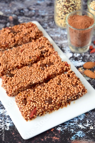 Healthy breakfast bars with puffed quinoa, cocoa powder, almond butter, goji berry, raisin, maple syrup and coconut butter