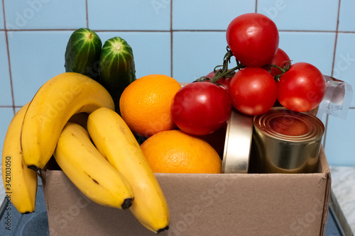 a large box with food and vegetables is in the kitchen, donations for those in need during self-isolation