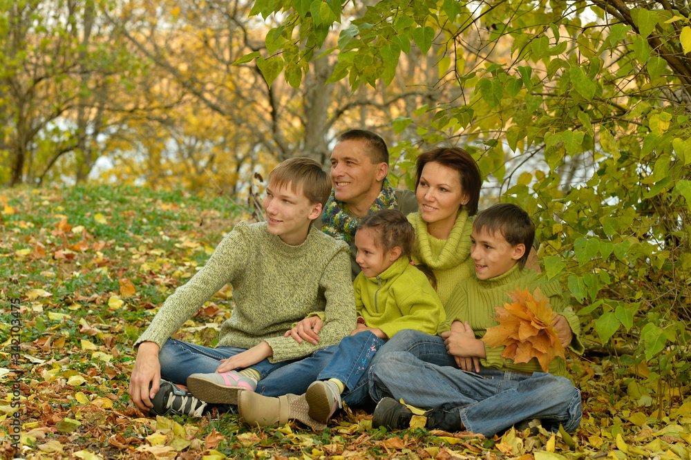 Portrait of family relaxing in autumn park Portrait of family relaxing in autumn park