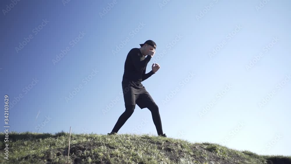 A guy struggles with a shadow in boxing in a field, on a field guy, on an island in a field A guy struggles with a shadow in boxing in a field, on a field guy, on an island in a field