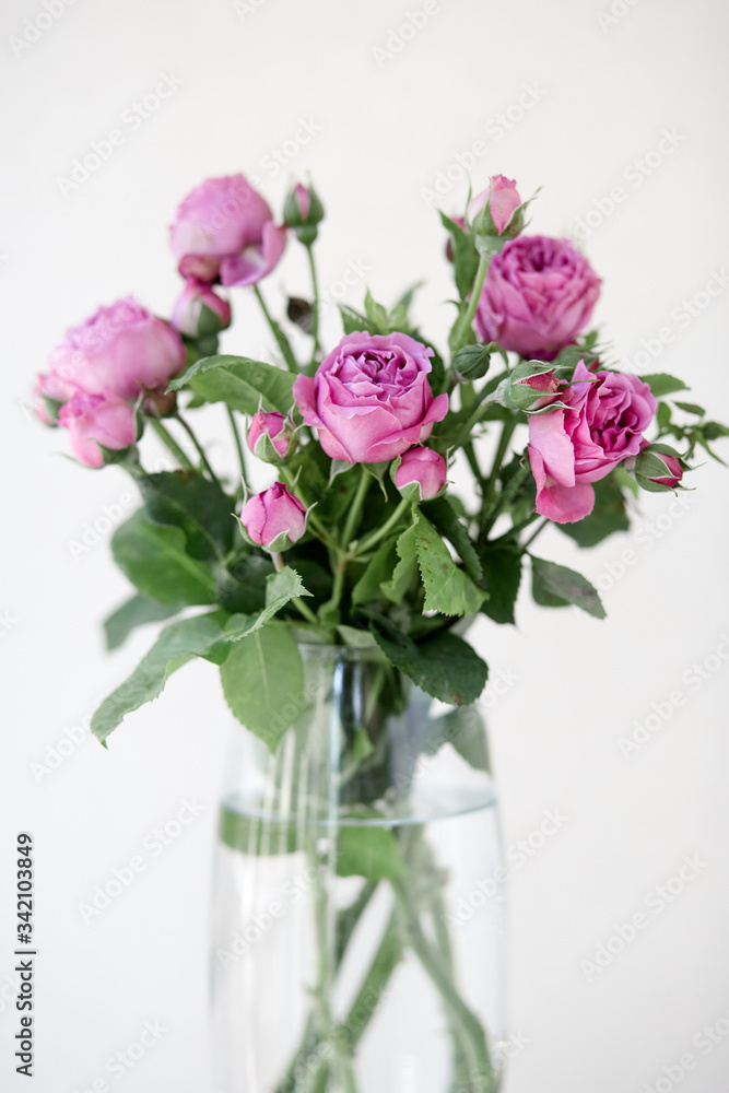 A bouquet of rose flowers in a vase on a table A bouquet of rose flowers in a vase on a table