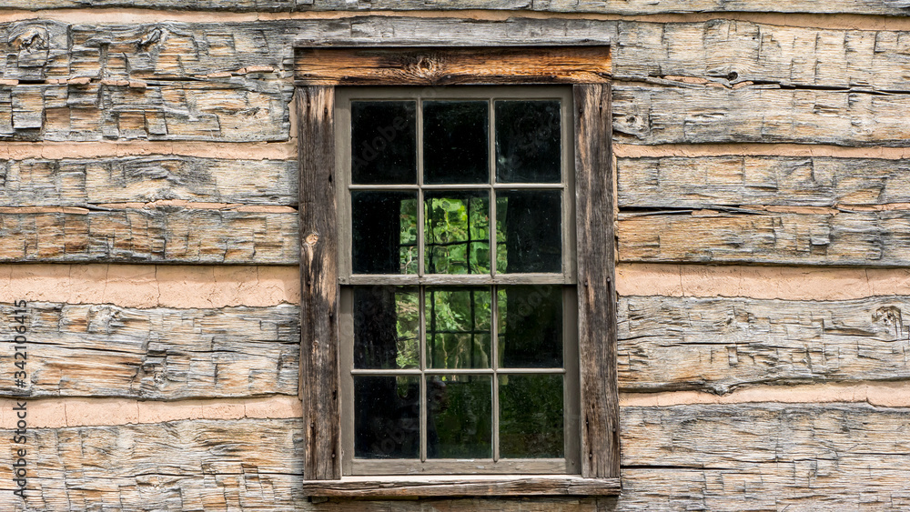 Window in an old wooden house of the times of american exploration Window in an old wooden house of the times of american exploration