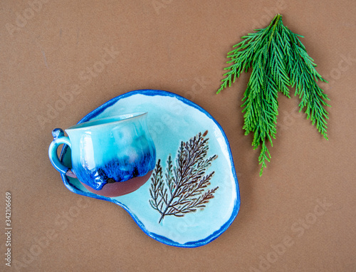 colorful handmade ceramic coffee cup with leaf	