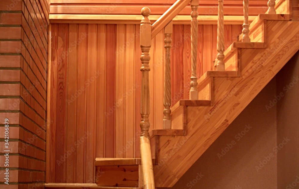 Fototapeta premium Wooden staircase from the hall to the second floor