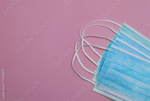 Surgical face masks against purple background with text space