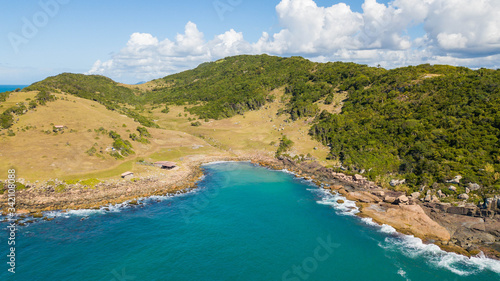 Aerial view of Maço beach, in Palhoça. Beautiful beach among green mountains and rocks in Santa Catarina, Brazil © Jair