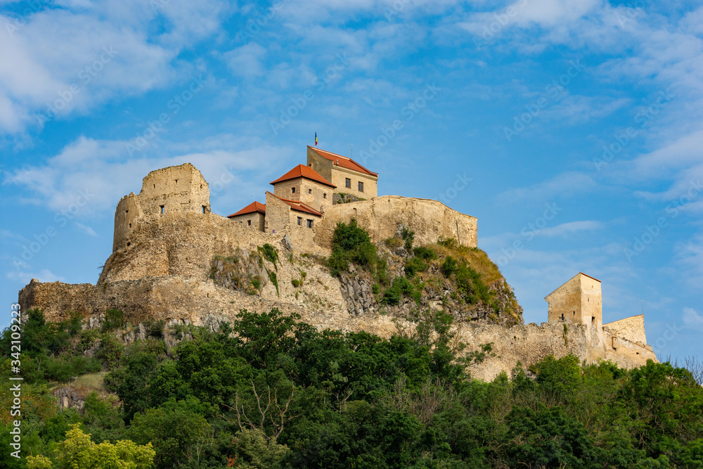 Beautiful view of the Rupea Stronghold on a blue sky with white clouds, Rupea, Brasov, Romania