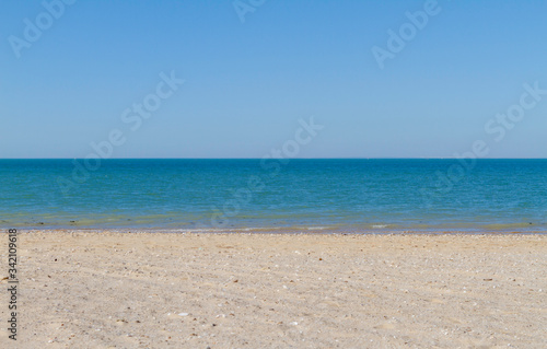 Sky, sea, sand and nobody on sunny beach. Vacation and relax. Tourism