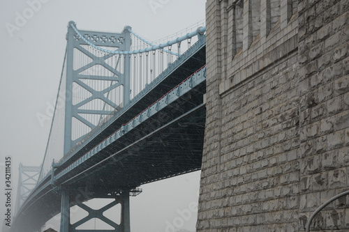 PHILADELPHIA, PENNSYLVANIA, USA - MARCH 19, 2018: View of Ben Franklin Bridge in snowy and foggy weather