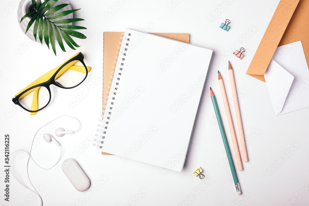 Freelancer workplace top view. Stay at home, work and study online. Notepad, stationery. Light background, flat lay Freelancer workplace top view. Stay at home, work and study online. Notepad, stationery. Light background, flat lay