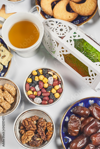 Iftar foods on white table. Traditional middle-eastern lunch with cookies and sweets