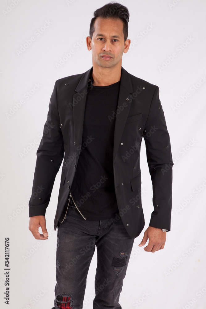 Fototapeta premium Handsome man in black shirt and jacket looking thoughtful