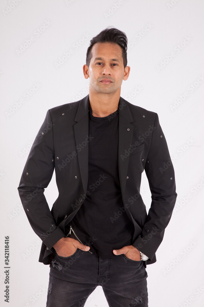 Fototapeta premium Handsome man in black shirt and jacket looking thoughtful