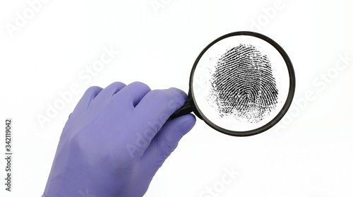 Hand holds a magnifying glass. fingerprint,