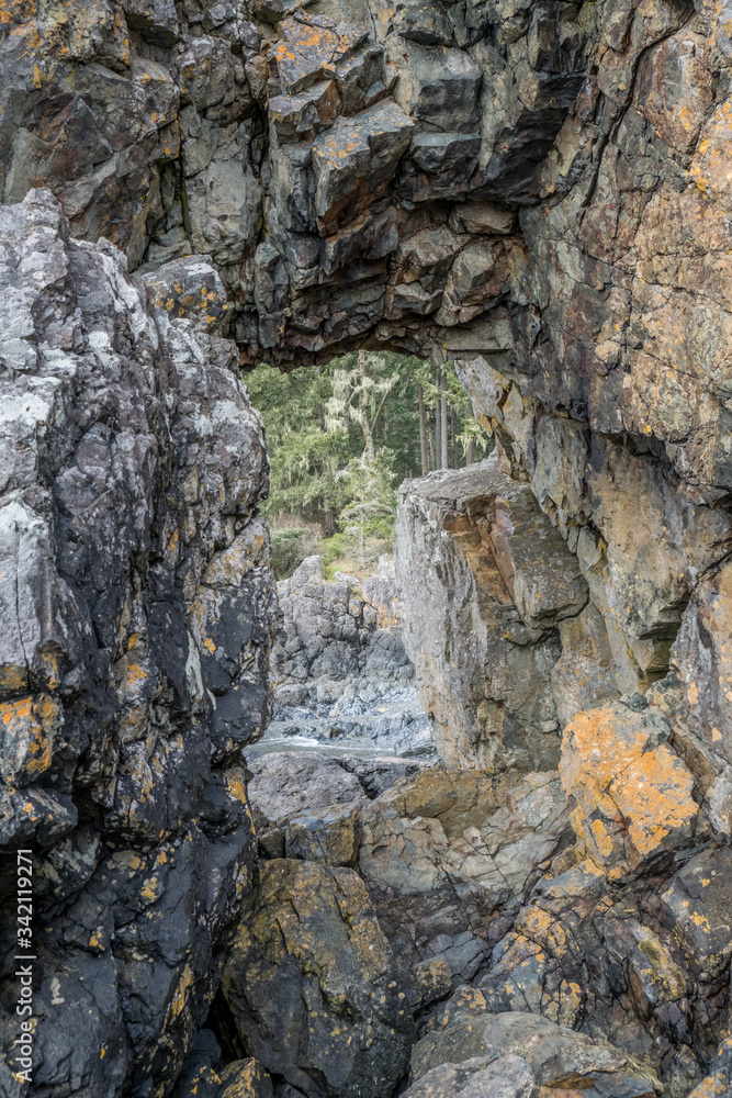 Vertical rock arch window opening in Canada northwest
