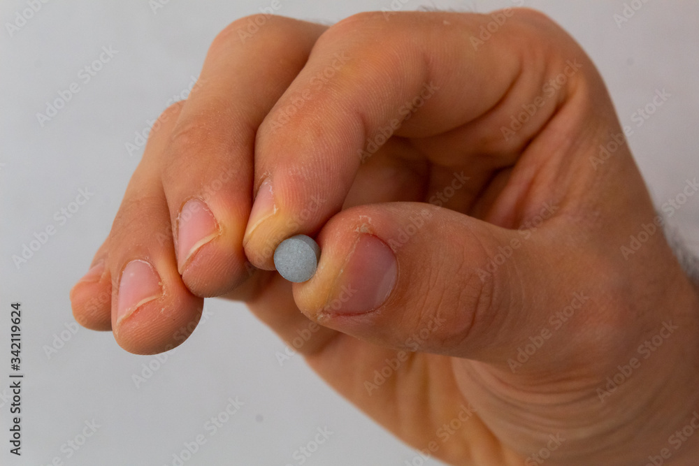 hands holding pills in different positions, with a flat background, concept of cure for diseases hands holding pills in different positions, with a flat background, concept of cure for diseases