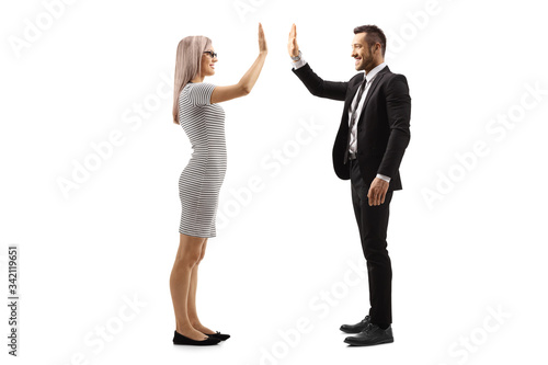 Young woman gesturing high-five with a businessman