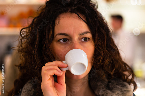young woman drinking a cup of coffee
