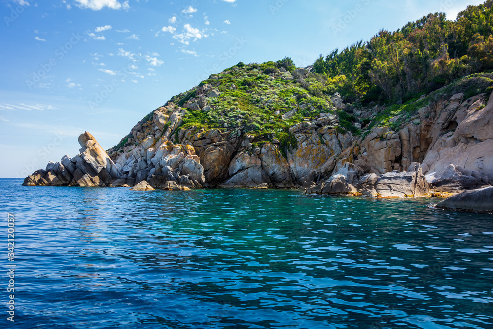 View of the rocky coast of Giglio island with mediterranean vegetation (Grosseto, Tuscany, Italy).