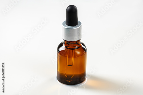 Skincare serum bottle on a light beige background close up