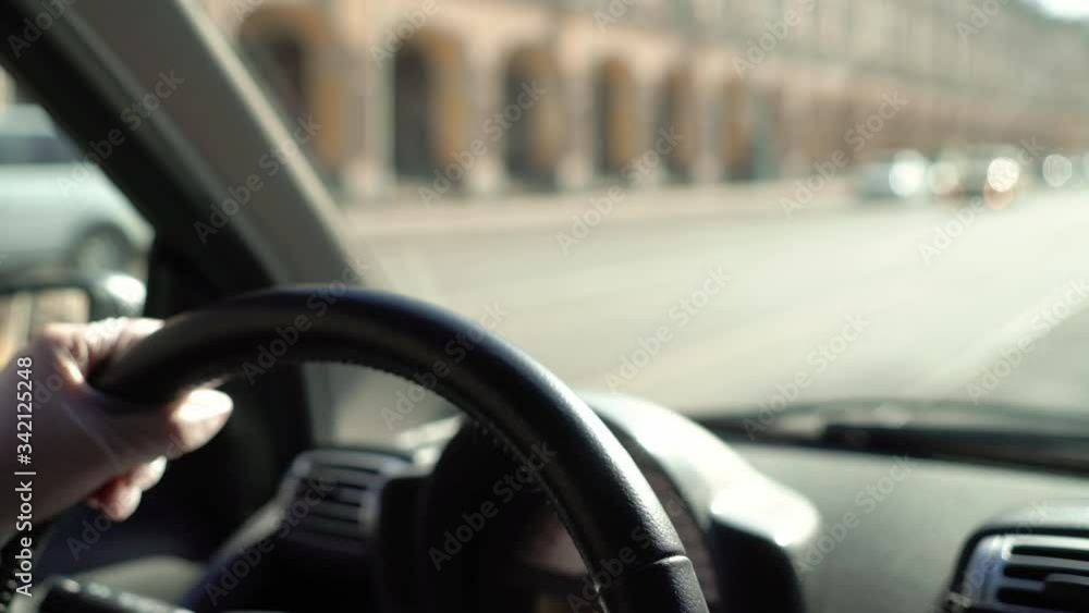 Young woman driving car in protective gloves. Pandemic of coronavirus covid-19. Young woman driving car in protective gloves. Pandemic of coronavirus covid-19.