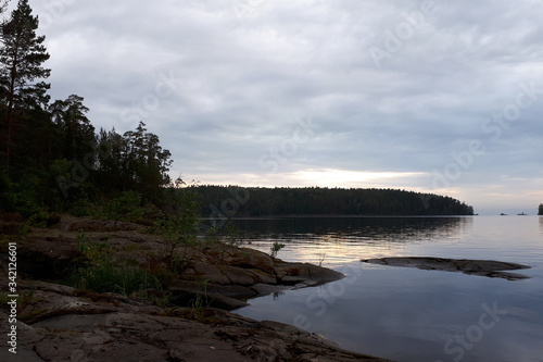 Calmness on Lake Ladoga on a cloudy day. Northern nature of Karelia. Travel to Russia. photo