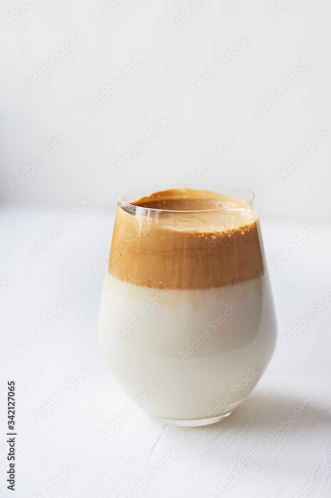 Cold coffee cream with cold Dalgon milk. Trend. In a transparent glass on a white background. Cold coffee cream with cold Dalgon milk. Trend. In a transparent glass on a white background.