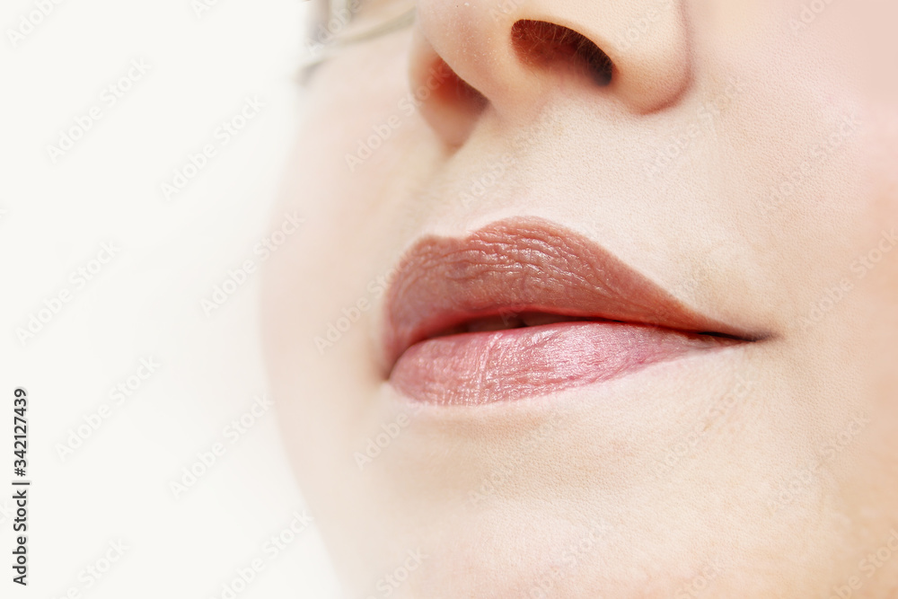 lips and lower face of a woman, the concept of cosmetic anti-aging procedures, facial massage, decorative cosmetics