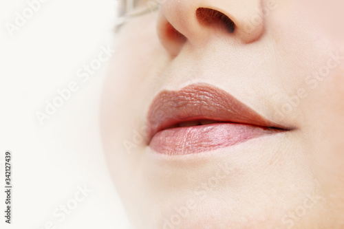 lips and lower face of a woman, the concept of cosmetic anti-aging procedures, facial massage, decorative cosmetics