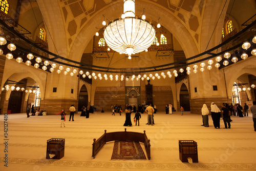 MANAMA, BAHRAIN - JUNE 26: Tourists visits the Al Fateh Grand Mosque on June 26, 2017, Manama, Bahrain. Al Fateh mosque is one of the largest mosque in the world photo