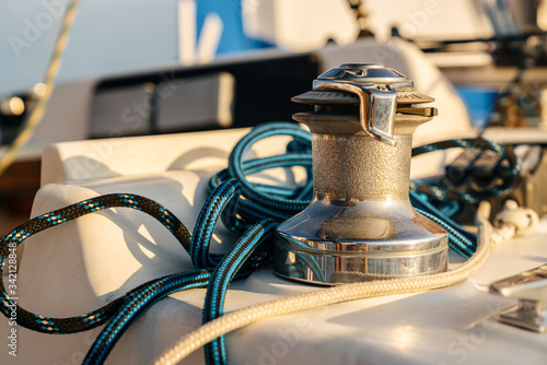 winch with blue rope, on the deck of a marine yacht. Details of the ship. © galaganov