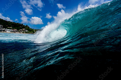 A wave breaks on a reef in a tropical paradise beach 