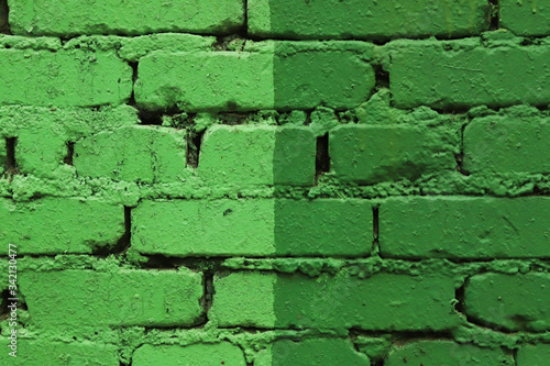 background of light and dark green painted bricks