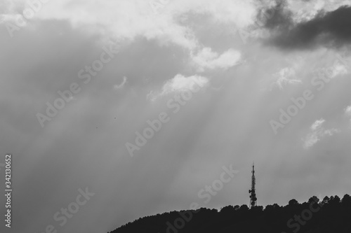 Mountain with the silhouette of a telecommunication antenna on a stormy afternoon